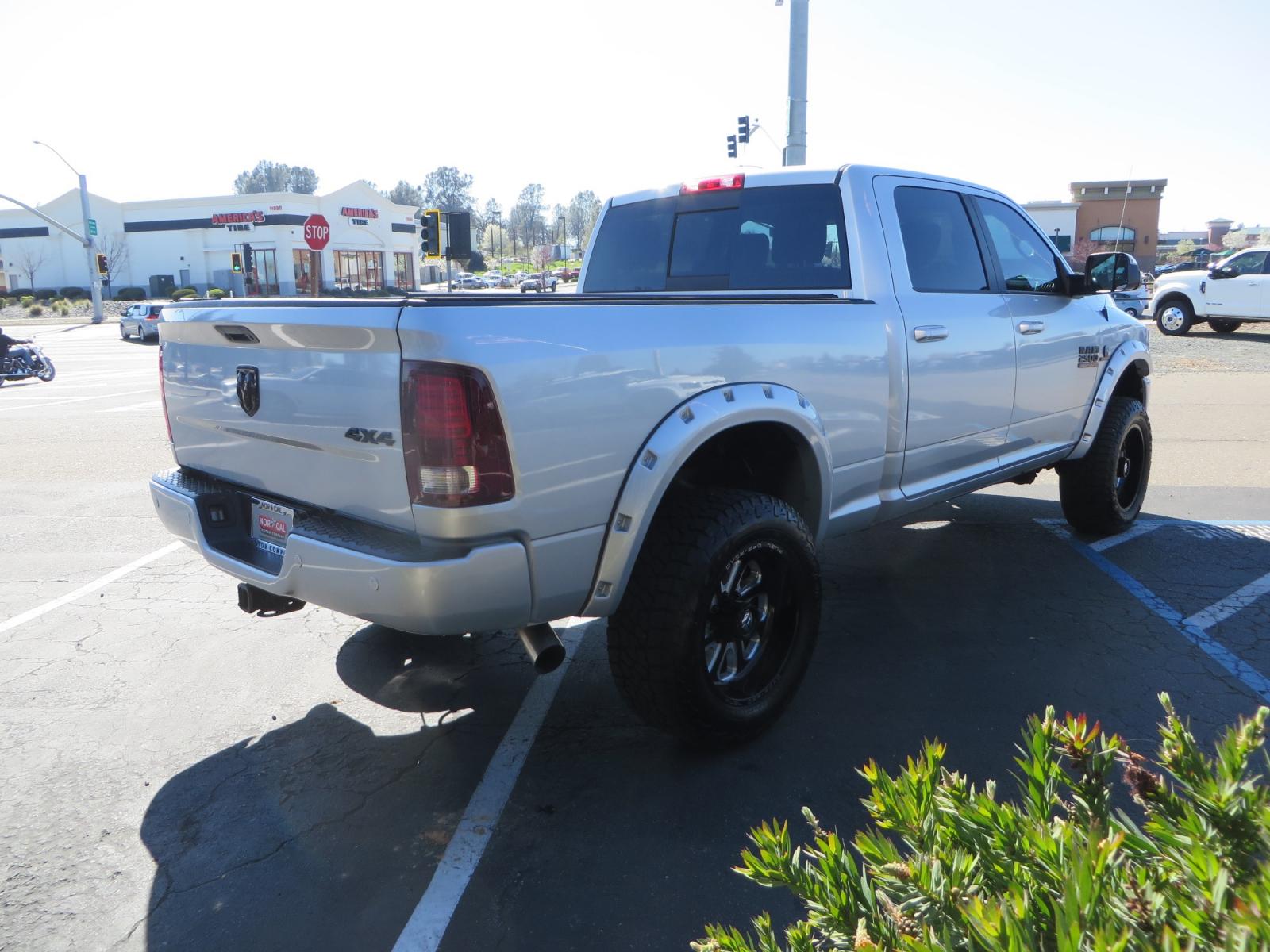 2016 SILVER /BLACK RAM 2500 Laramie Crew Cab SWB 4WD (3C6UR5FL3GG) with an 6.7L L6 OHV 24V TURBO DIESEL engine, 6A transmission, located at 2630 Grass Valley Highway, Auburn, CA, 95603, (530) 508-5100, 38.937893, -121.095482 - Leveled Ram sitting on Fuel Offroad wheels, Falken Wildpeak AT tires, Amp Power steps, Rolling Bed cover, Color matched fender flares, and window tint. - Photo #4